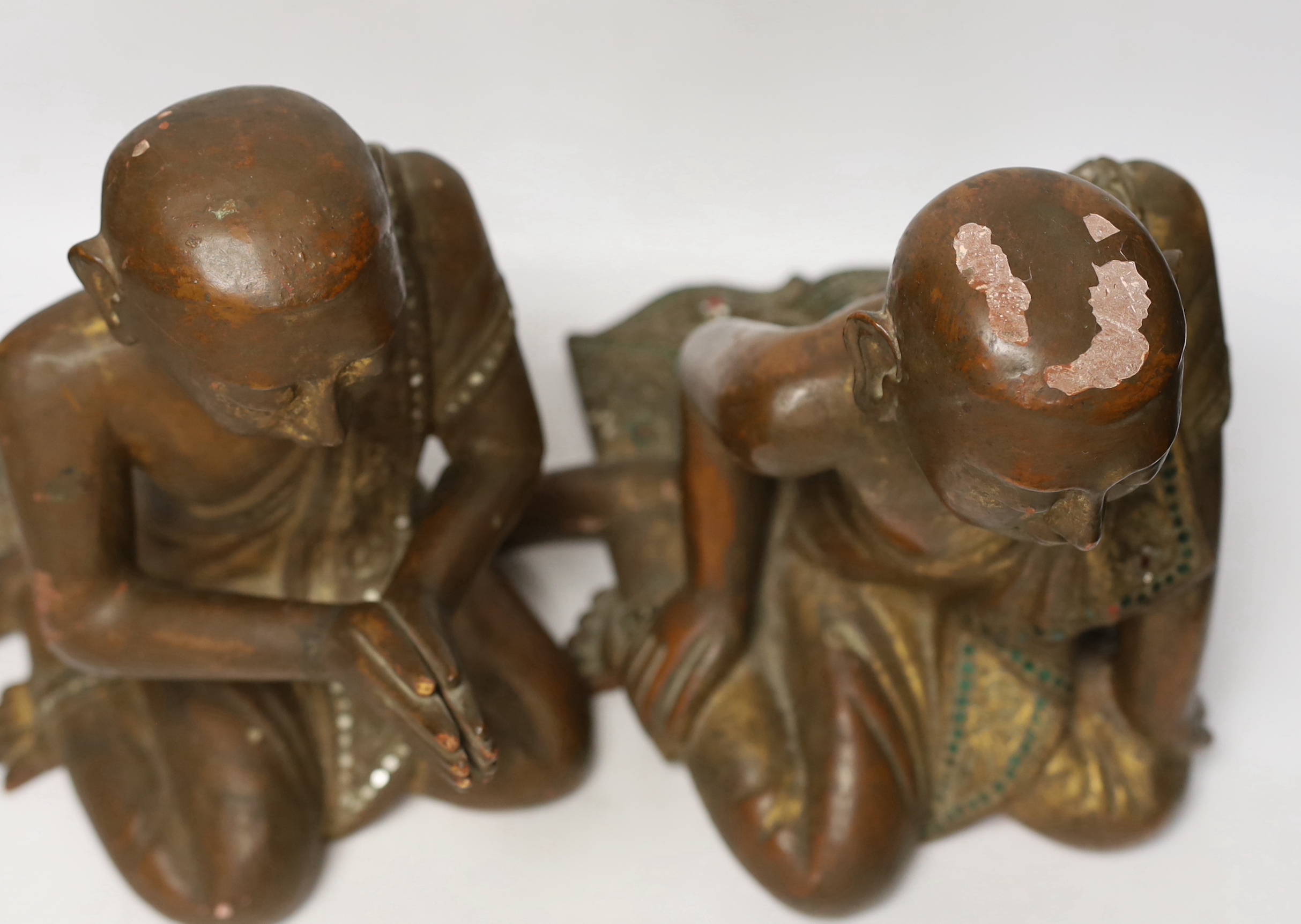 Two papier-mâché and lacquer Thai praying monks, 29.5cm high